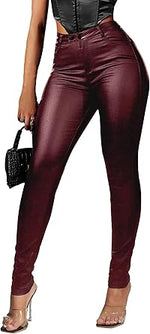 Burgundy leather pants worn by a person, with a handbag held in the other hand.