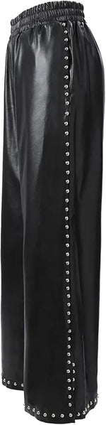 Black leather pants with studded details on a plain background
