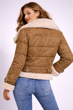 Woman wearing a brown suede jacket with white fur trim on a white background